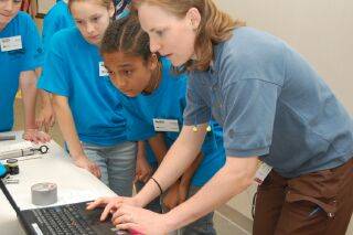 Howmet employee works with campers